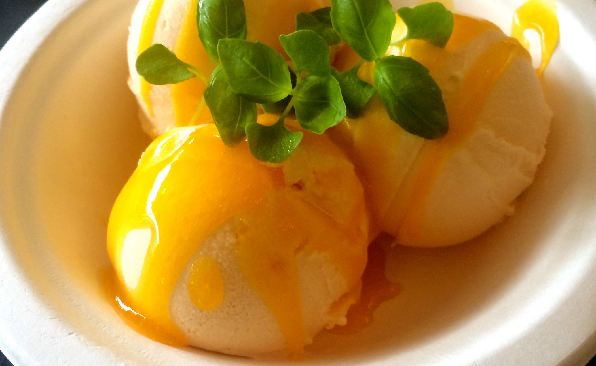 Passion fruit ice cream with yellow bell pepper sauce and chili